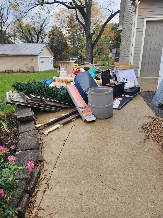 Dumpster being loaded with debris for Residential Dumpster Rental in Foxborough
